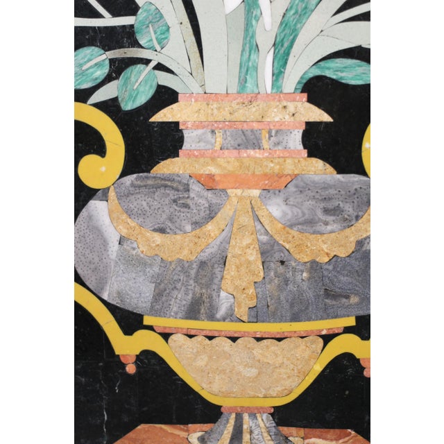 A fabulous and unique pietra dura headboard in black with a bouquet of flowers in an urn centered. A brass inlaid strip...