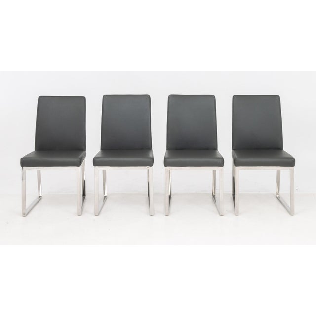 Set of Four Milo Baughman Style Chrome Dining Chairs, with gray faux leather upholstered seats and backs. 35" H x 18.5" W...
