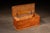 Rectangular wooden blanket chest constructed with hand-cut dovetail joinery at the case corners and an original iron strap...