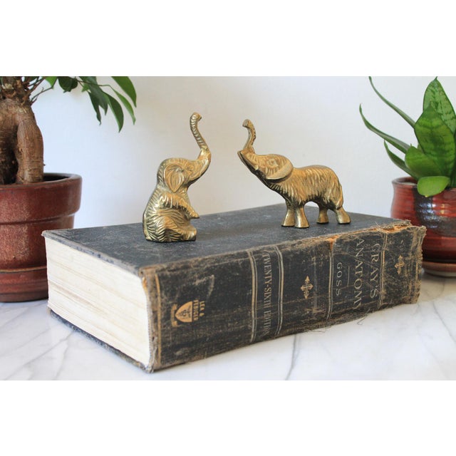 Pair of vintage brass elephant figurines. Makers mark on the bottom of one. Made in Taiwan R.O.C. Minor age wear. Sitting,...