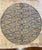 This piece features a striking symmetrical design, with circular, spiral, and diamond motifs carefully hand-drawn in black...