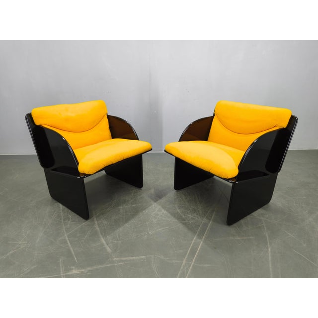 Elegant pair of Italian armchairs from the 1970s designed in a bold space age style. The chairs feature a sculptural...