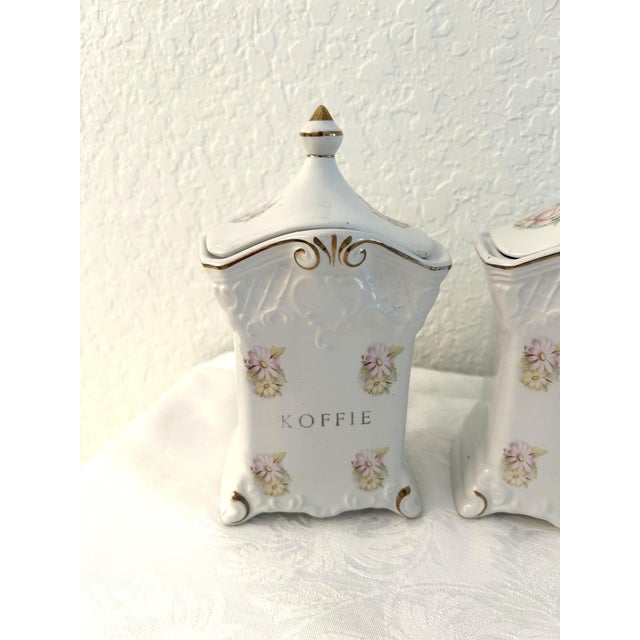 Lovely set of three white porcelain lidded Dutch coffee, tea and sugar canisters featuring a Victorian design motif with...