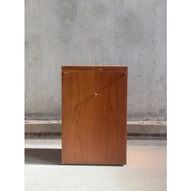 Captain's bar designed by Reno Wahl Iversen for dyrlund Denmark 1960s. Closed a sleek compact teak cabinet, opened a fully...