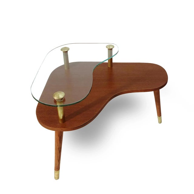 A Pair of Sculptural Mid-Century Modern side Tables. Made of Walnut, with Floating glass tops and Brass details. 1960's.