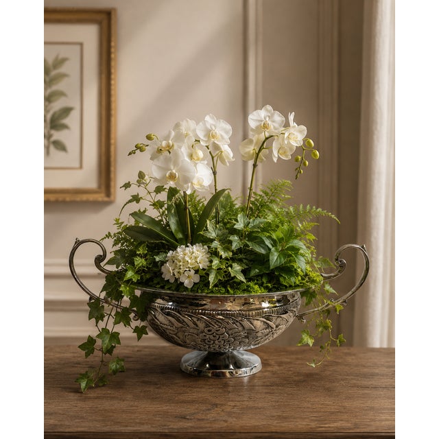 A stately oval shaped hammered Silverplated Repousse Jardiniere with dramatic scrolling trophy handles. Circa Mid 20th...