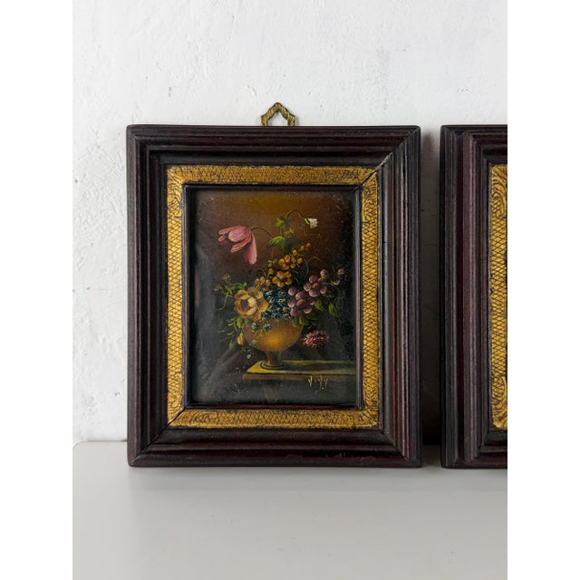 A beautiful pair of antique oil paintings on copper depicting elegant floral still lifes in classical urns. Richly...