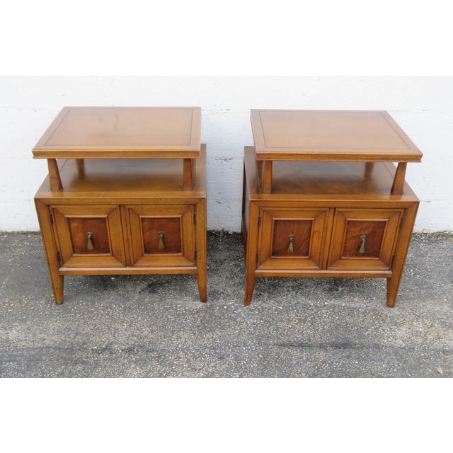 This beautiful Pair of Nightstands is made of wood, walnut, burlwood, and veneer. We believe they were made by Fancher...