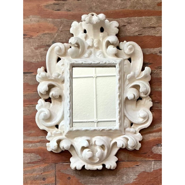 This charming small wall mirror captures the extravagant curvature and decorative richness of the Rococo style,...
