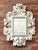 This charming small wall mirror captures the extravagant curvature and decorative richness of the Rococo style,...