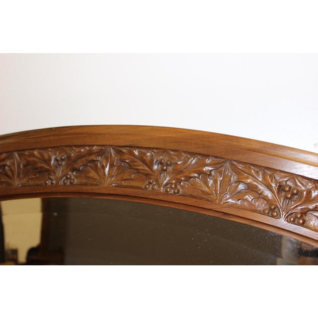 Large Art Nouveau period mirror in walnut and beveled mirror, decor of leaves and holly balls, around 1900, very good...