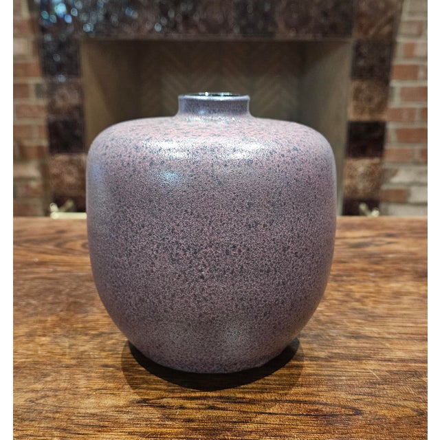 This mid-century modern West German art pottery vase features a matte Amethyst finish and a classic bulbous, apple-like...