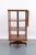 Spinning side table bookcase with an adjustable reading stand in medium toned wood. Streamlined geometric design and an...