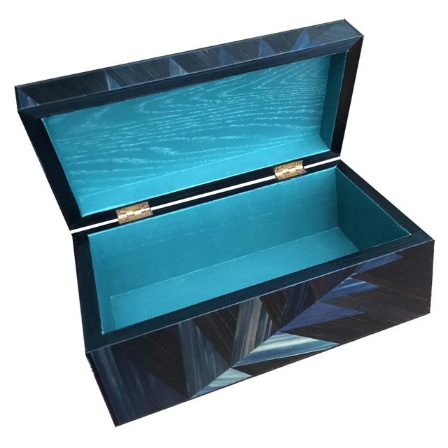 This decorative box is made from blue and black straw marquetry with mahogany and finished inside with ocean blue satin....
