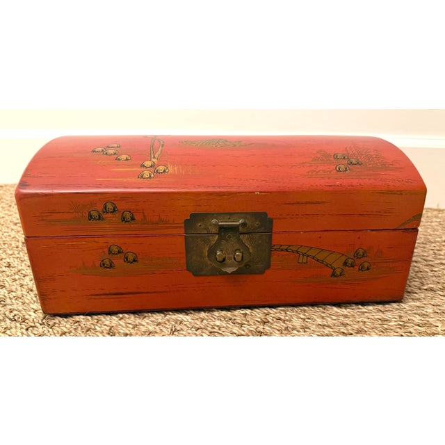 Domed top cinnabar red box. Gilded Asian raised detailing to the top and sides. Red silk interior, can be use as a jewelry...