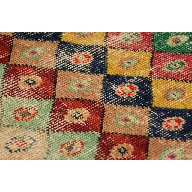 Hand-knotted in wool and originating from Turkey circa 1960 – 1970, this 2x3 vintage Zeki Müren rug is a unique addition...