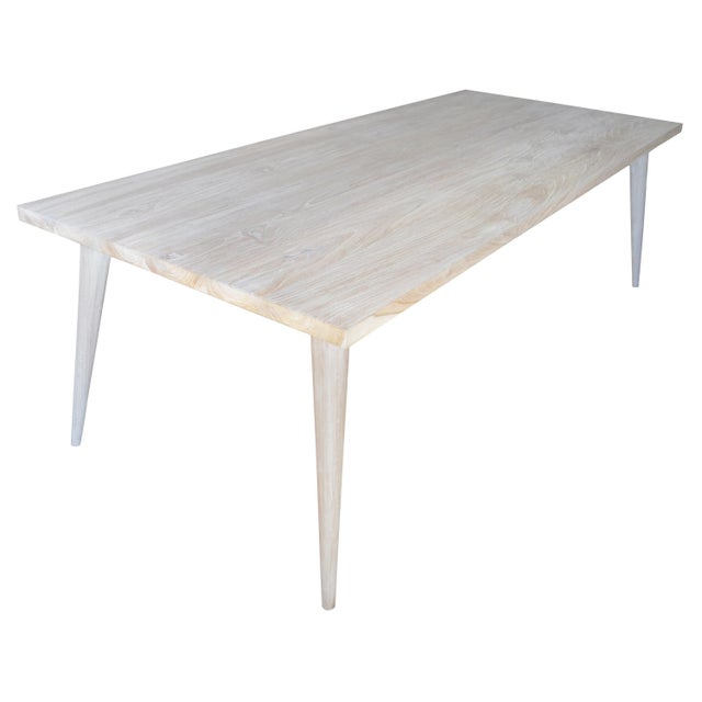 Reclaimed teak wood dining table with modern lines set on a mid century style base. White washed revealing the beautiful...