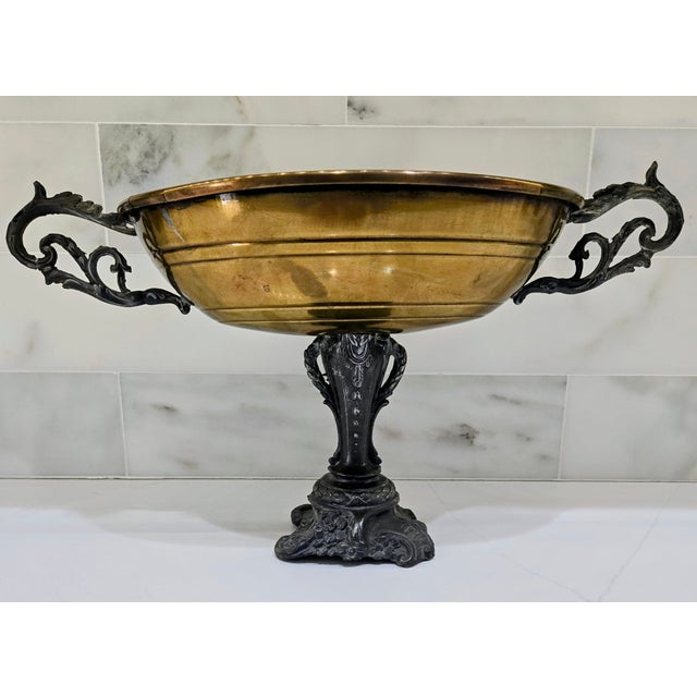 Rococo-style mixed metal compote centerpiece featuring a warm gilt brass oval bowl raised on an ornate silver-tone spelter...