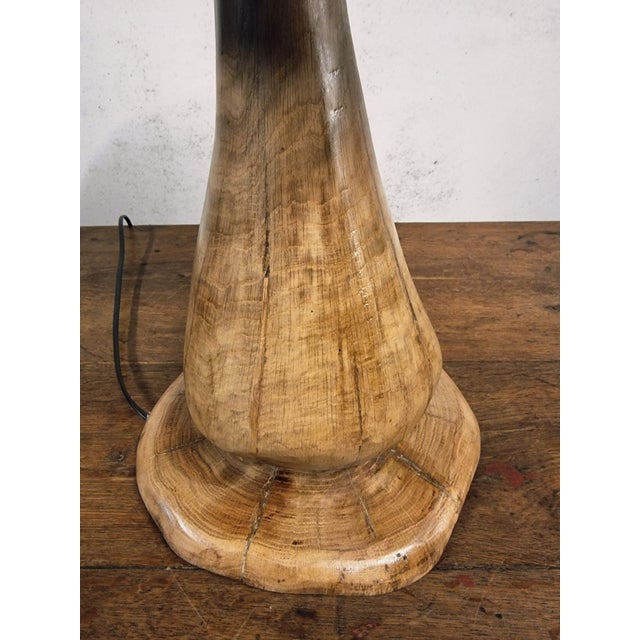 This table lamp is handcrafted from a single piece of solid oak wood by a local furniture maker and artist in the Allier...