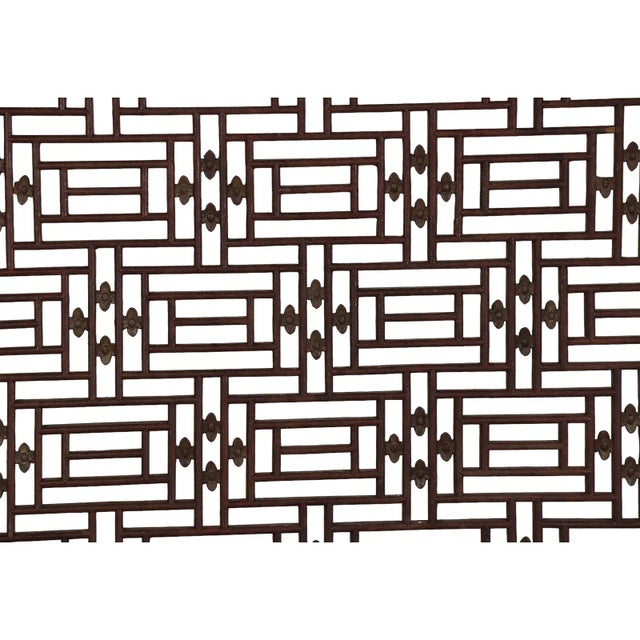 A Chinese antique 19th Century carved wood window panel. Pierced openwork criss-crossed design with gilt flowers. No...