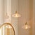 Light and airy, this pendants composition is simple: a single hand-blown glass shade, warm antiqued brass iron, and...
