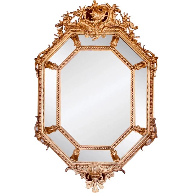 An eye-catching confection of Rococo decorative elements, combined in a cushion mirror with sober classical architectural...