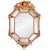 An eye-catching confection of Rococo decorative elements, combined in a cushion mirror with sober classical architectural...