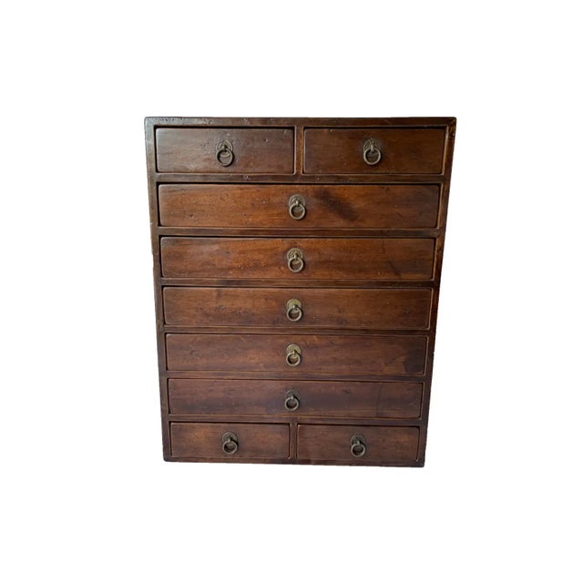 A 19th century camphor wood lacquered Chinese scholar cabinet from the Qing Dynasty. It features original fittings which...