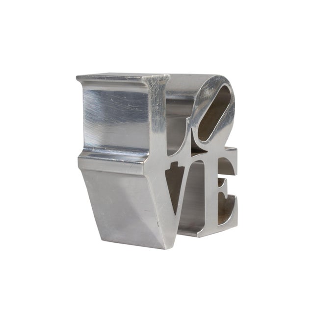 A vintage chrome LOVE paperweight. This paperweight is based on the sculpture LOVE by American artist Robert Indiana...