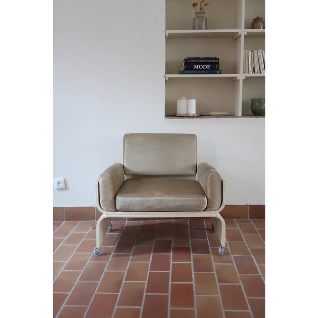 A 1970s space age lounge chair with a bentwood shell lacquered white and three original beige velvet cushions. The bold,...