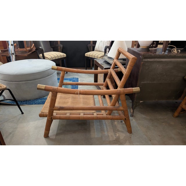 These beautiful vintage lounge chairs, crafted from natural bamboo and rattan, feature elegant brass accents that truly...