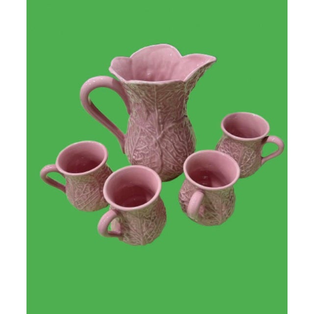 A very rare Midcentury pink set of lettuce ware a pitcher with 4 matching cups. The marking is a town in Portugal where it...