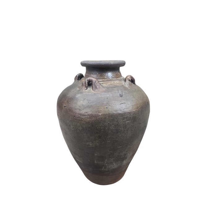 Primitive Southeast Asian Pottery Vessel with Four Lug Handles Hand-thrown earthenware storage vessel featuring a rounded...
