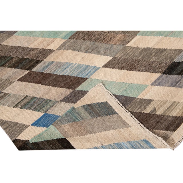 Beautiful modern Kilim flat-weave wool rug. This Kilim rug full of art has a brown, green, and blue field in a gorgeous...