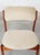 Frame made of solid teak. Upholstered in fabric. The seats of three of the chairs have been reupholstered. One chair has a...
