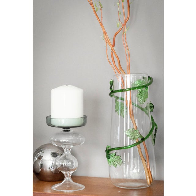 Liane vase, is made in transparent mouth blown glass, with an handmade green liane rolling up the surface. Meticulously...
