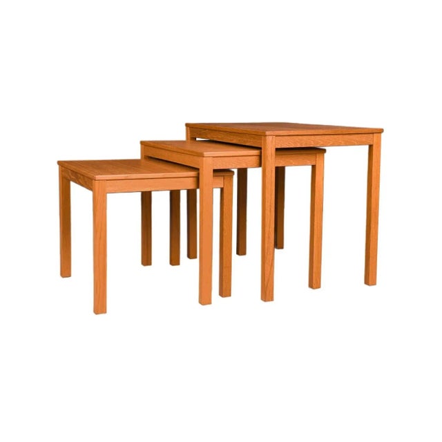 Set of three Mid Century Modern teak, rectangular nesting tables. Exceptionally well crafted. Undersides of the tables are...