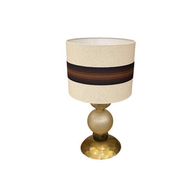 Table lamp with spheres and pieces in Murano glass in brown tones. The base and structure are made of gilded brass. The...