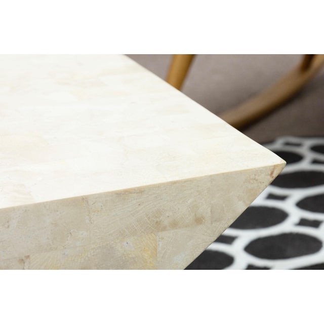 This post modern coffee table showcases a bold architectural form crafted from polished tesselated stone in soft, neutral...