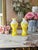Striking pair of late 19th-century art glass vases featuring substantial opaque white glass bodies with vivid yellow glass...