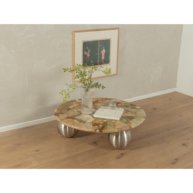 Exclusive coffee table from the 1960s with a onyx marble top in shades of off white, beige, green and brown and new ball...