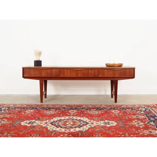 The lowboard was made in the 1970s, Danish production. The structure was covered with teak veneer. Legs and handles made...