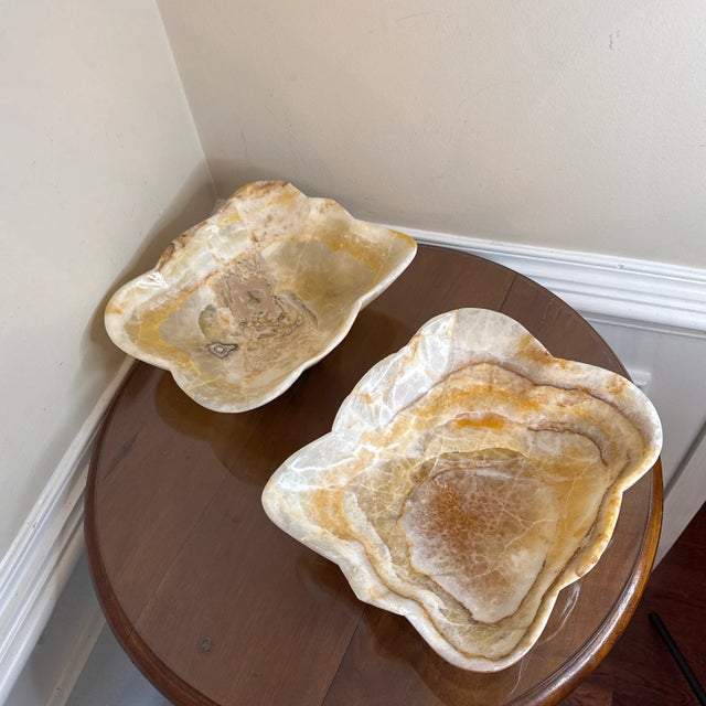 This unique, handcrafted bowl is made from onyx, a luxurious and exotic stone. The bowl features a scalloped edge, adding...