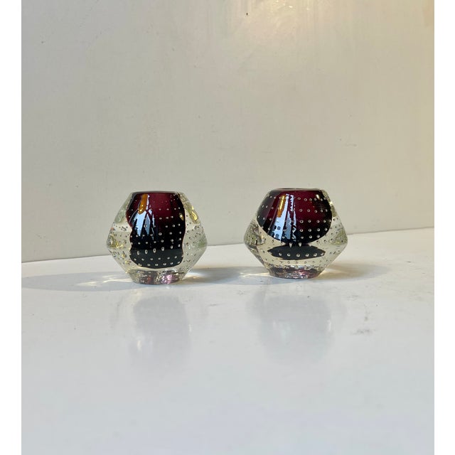 A pair of vintage Scandinavian glass candlesticks, manufactured ca. 1950s-70s. For regular sized candles. This design is...