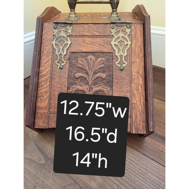 Beautiful oak coal scuttle with carved oak details and Brass mounts.