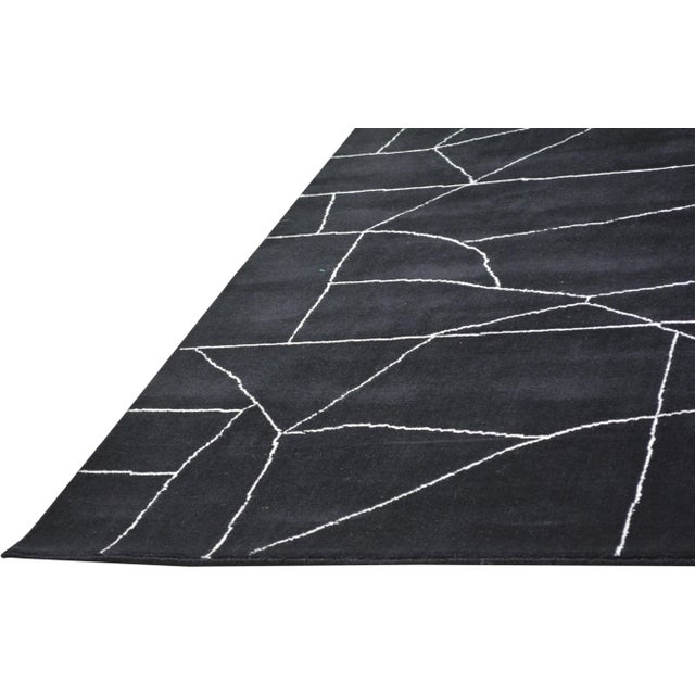 Hand-knotted with care using traditional rug-making techniques, this wool rug blends timeless craftsmanship with a modern...