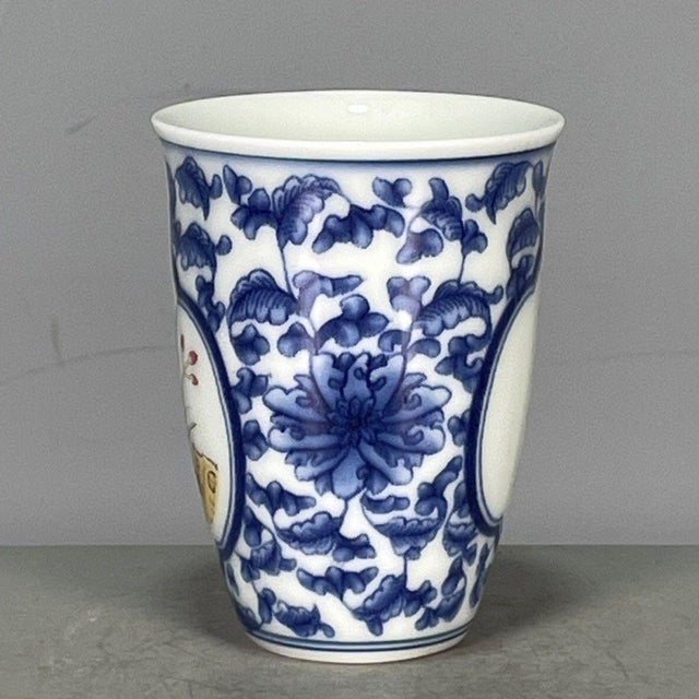 This is an elegant vintage porcelain cup, possibly a "smelling cup" (闻香杯) used in tea ceremonies, decorated in a...