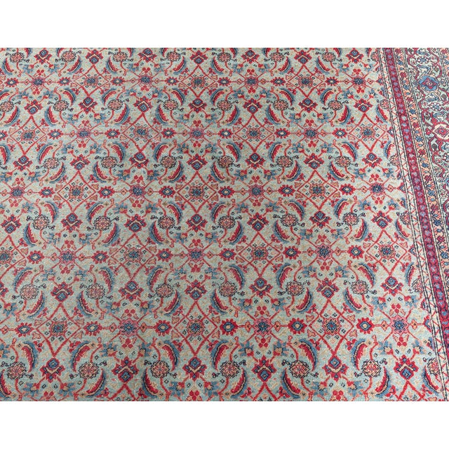 A Late 19th century Persian Tabriz rug. Finely woven with an intricate all-over design. Abstract floral motifs with...