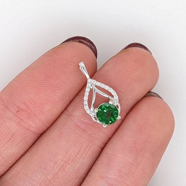 This beautiful pendant features a sparkling light green 0.56ct tsavorite pendant with natural earth-mined diamonds in...