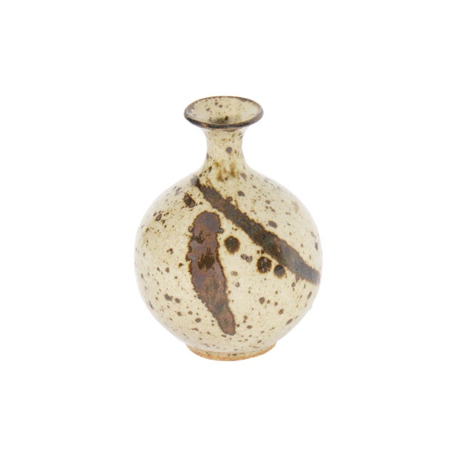 A studio pottery bud vase by the American ceramicist Laura Andreson (1902-1999). This vase has a narrow neck and a...